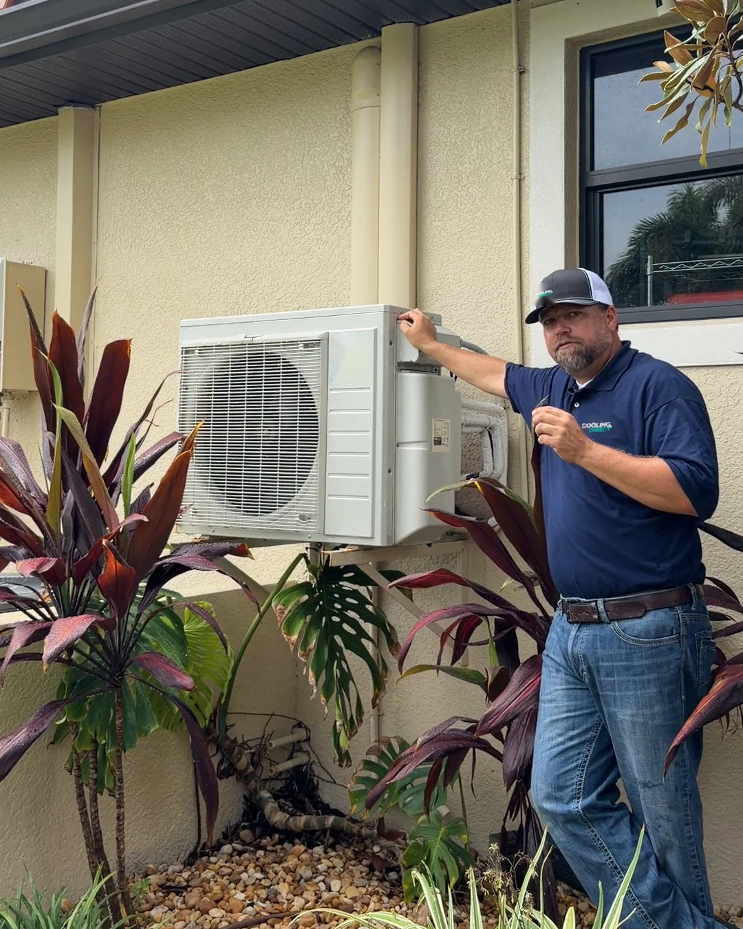 Jeren of Cooling Direct beside a mini-split at a Southwest Florida home